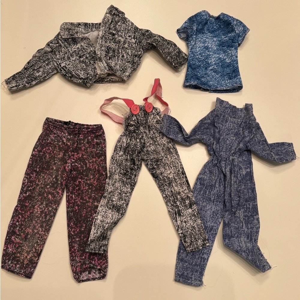 collection of vintage Barbie clothes in the iconic acid wash aesthetic